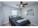 Bedroom features vinyl flooring, neutral walls, ceiling fan, and a bright window with white blinds at 1570 S Michigan Ave, Clearwater, FL 33756