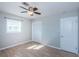 Bedroom with neutral walls, vinyl floor, and a bright window with white blinds at 1570 S Michigan Ave, Clearwater, FL 33756