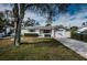 Charming single-story home with a well-manicured lawn, garage, and American flag displayed at 1570 S Michigan Ave, Clearwater, FL 33756