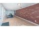 Bright living room with wood floors and brick accent wall at 1570 S Michigan Ave, Clearwater, FL 33756