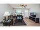 Cozy living room with neutral walls, a ceiling fan, and a large window for natural light at 1570 S Michigan Ave, Clearwater, FL 33756