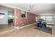 Bright living room with wood floors and brick accent wall at 1570 S Michigan Ave, Clearwater, FL 33756