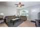 Inviting living room with neutral walls, ceiling fan and a large window with a view at 1570 S Michigan Ave, Clearwater, FL 33756