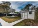 A well-maintained shed in a backyard setting, surrounded by greenery and a decorative fountain at 1570 S Michigan Ave, Clearwater, FL 33756