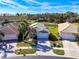 Aerial view of a residential area including a home with a white garage door at 15856 Cobble Mill Dr, Wimauma, FL 33598