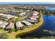 Aerial view of neighborhood with lake and homes at 15856 Cobble Mill Dr, Wimauma, FL 33598