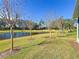 Backyard with lake view and several trees at 15856 Cobble Mill Dr, Wimauma, FL 33598