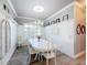 Elegant dining room with white table and chairs, hardwood floors and chandelier at 15856 Cobble Mill Dr, Wimauma, FL 33598