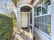 Front entrance with white door and a decorative wall accent at 15856 Cobble Mill Dr, Wimauma, FL 33598