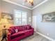 Relaxing guest room, featuring a red sofa at 15856 Cobble Mill Dr, Wimauma, FL 33598