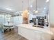 Modern kitchen with white cabinets, quartz countertops, and stainless steel appliances at 15856 Cobble Mill Dr, Wimauma, FL 33598