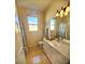 Bathroom with white cabinets and a large mirror at 16103 Muirfield Dr, Odessa, FL 33556