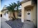 Front entrance of a house with palm trees and stone landscaping at 16103 Muirfield Dr, Odessa, FL 33556