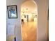 View of the living area from the dining room, showing hardwood floors at 16103 Muirfield Dr, Odessa, FL 33556