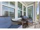 Relaxing balcony with wicker chairs and sliding glass doors at 16317 Gulf Blvd, Redington Beach, FL 33708