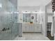 Elegant bathroom with double vanity, large shower, and marble flooring at 16317 Gulf Blvd, Redington Beach, FL 33708