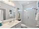 Clean bathroom with a shower, white tile, and a vanity at 16317 Gulf Blvd, Redington Beach, FL 33708