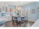 A round table and chairs sit in this well-lit breakfast nook at 16317 Gulf Blvd, Redington Beach, FL 33708