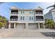 Three-story house featuring three-car garage and multiple balconies at 16317 Gulf Blvd, Redington Beach, FL 33708