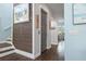 Hallway showcasing wood-like wall accents and hardwood floors at 16317 Gulf Blvd, Redington Beach, FL 33708