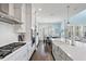 Spacious kitchen featuring white cabinets, stainless steel appliances, and a herringbone backsplash at 16317 Gulf Blvd, Redington Beach, FL 33708