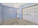 Bedroom with light blue walls, neutral carpet, and a large closet at 1702 S Miller Rd, Valrico, FL 33594