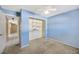 Bedroom with light blue walls, neutral carpet, and a large closet at 1702 S Miller Rd, Valrico, FL 33594