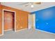 Bedroom with orange and blue walls, and a closet at 1702 S Miller Rd, Valrico, FL 33594