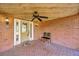 Brick front porch with a ceiling fan and two chairs at 1702 S Miller Rd, Valrico, FL 33594