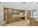 Kitchen boasts ample cabinetry and granite countertops at 1702 S Miller Rd, Valrico, FL 33594