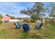 Backyard features fire pit area, an entertainment area and mature trees at 1707 Darlington Dr, Tampa, FL 33619