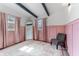 Bedroom with pink wainscoting, wood-look floors, and natural light from the windows at 1707 Darlington Dr, Tampa, FL 33619