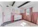 Charming bedroom featuring a decorative pink accent wall and stylish, neutral furnishings at 1707 Darlington Dr, Tampa, FL 33619