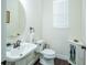 This bathroom offers a pedestal sink, decorative mirror, and a modern feel at 1708 Sunset Wind Loop, Oldsmar, FL 34677