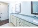 Bathroom with a granite countertop vanity, white cabinets, dual sinks, and a framed mirror at 1708 Sunset Wind Loop, Oldsmar, FL 34677