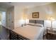 Comfortable bedroom with a queen bed, bedside tables with lamps, and a pleasant, neutral decor at 1708 Sunset Wind Loop, Oldsmar, FL 34677