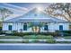 Charming Bayside Terrace clubhouse with a round window, surrounded by neat landscaping and manicured lawn at 1708 Sunset Wind Loop, Oldsmar, FL 34677