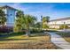 Bayside Terrace entrance sign nestled among lush palm trees and vibrant landscaping welcomes residents to a beautiful community at 1708 Sunset Wind Loop, Oldsmar, FL 34677