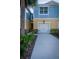 Exterior view of a townhome with a one car garage and well-manicured landscaping at 1708 Sunset Wind Loop, Oldsmar, FL 34677