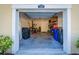 A spacious one-car garage featuring ample storage space, a back door, and room for parking at 1708 Sunset Wind Loop, Oldsmar, FL 34677