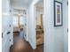 Hallway with wood floors and white walls leading to bedrooms and a sitting room at 1708 Sunset Wind Loop, Oldsmar, FL 34677