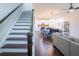 View of the main floor from the stairs leading to the second floor showcases the kitchen, dining, and living areas at 1708 Sunset Wind Loop, Oldsmar, FL 34677