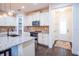 Modern kitchen with stainless steel appliances, granite island, and brick backsplash at 1708 Sunset Wind Loop, Oldsmar, FL 34677