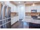 Modern kitchen featuring stainless steel appliances, granite countertops, and stylish backsplash at 1708 Sunset Wind Loop, Oldsmar, FL 34677