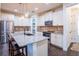 Bright kitchen with stainless steel appliances, an island with seating, and white cabinets at 1708 Sunset Wind Loop, Oldsmar, FL 34677