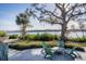 Outdoor seating area with adirondack chairs surrounding concrete table and views of the waterway at 1708 Sunset Wind Loop, Oldsmar, FL 34677