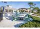 Outdoor seating area by pool features adirondack chairs surrounding concrete table, near community pool at 1708 Sunset Wind Loop, Oldsmar, FL 34677