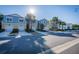 Neighborhood street with colorful townhomes, palm trees, and well-manicured landscaping at 1708 Sunset Wind Loop, Oldsmar, FL 34677