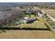 Aerial view of the estate, showcasing the pool, landscaping, and surrounding fields at 17336 Ballmont Park Dr, Odessa, FL 33556