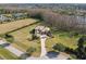 Aerial view of a luxurious estate with a long drive and beautiful landscaping and surrounding green space at 17336 Ballmont Park Dr, Odessa, FL 33556